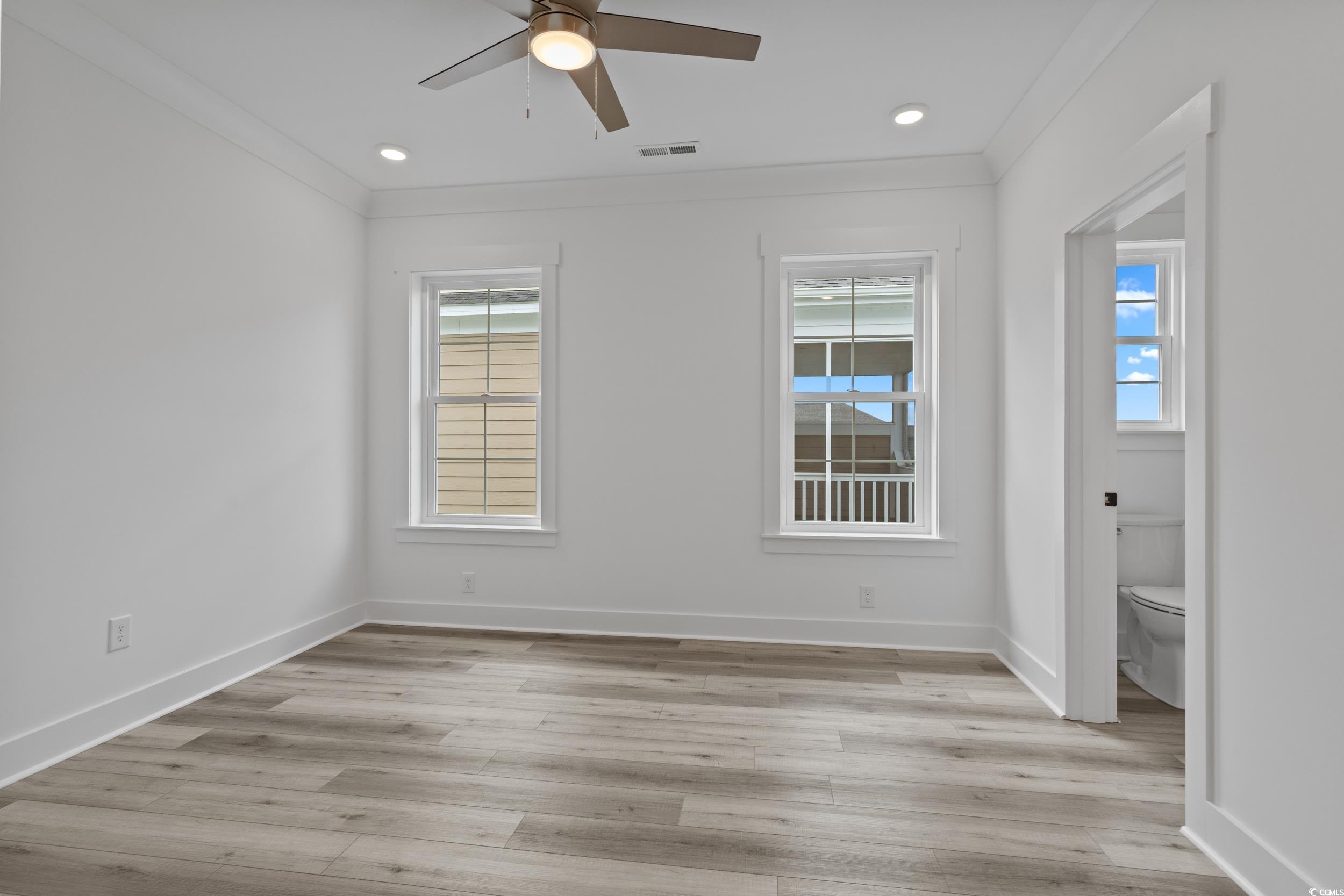 921 Crystal Water Way Myrtle Beach, SC 29579 - Photo 24 of 36 Unfurnished room featuring ornamental molding, light wood-style flooring, ceiling fan, and recessed lighting