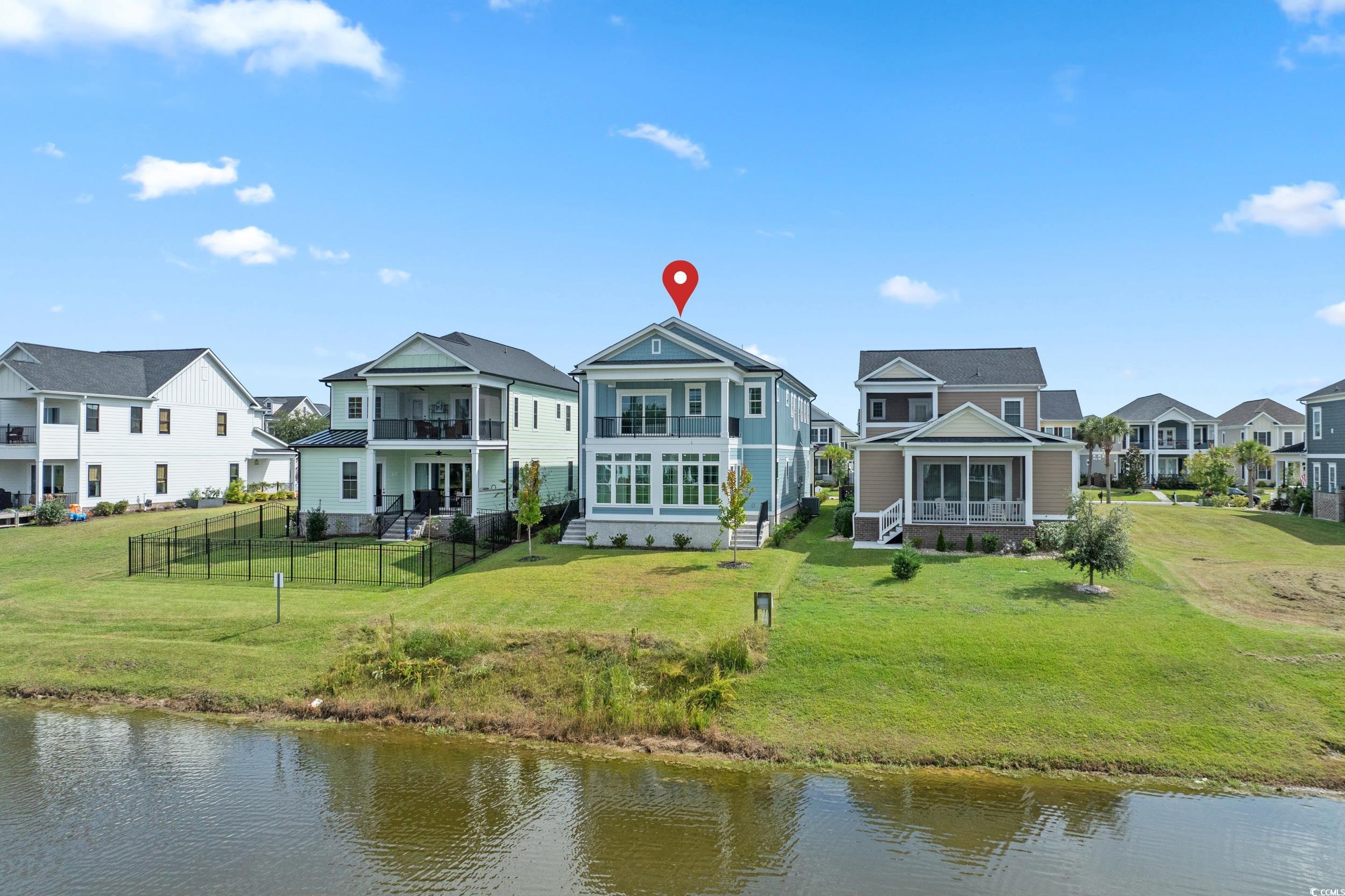 921 Crystal Water Way Myrtle Beach, SC 29579 - Photo 29 of 36 Back of house featuring a water view, a residential view, and a fenced backyard
