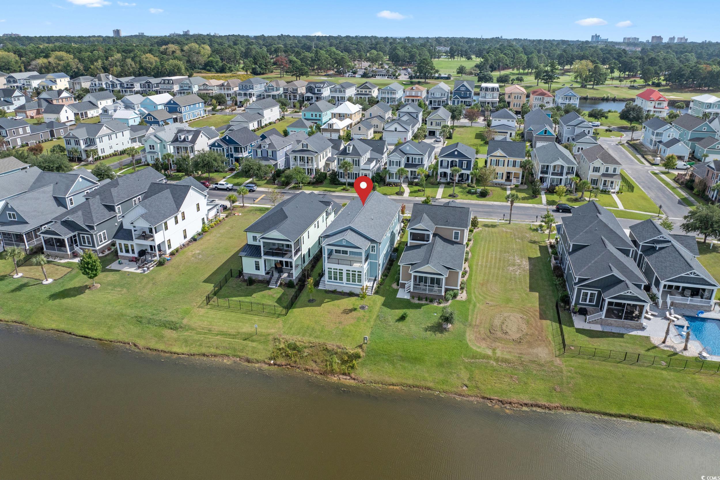 921 Crystal Water Way Myrtle Beach, SC 29579 - Photo 3 of 36 Aerial perspective of suburban area with a large body of water and a tree filled landscape