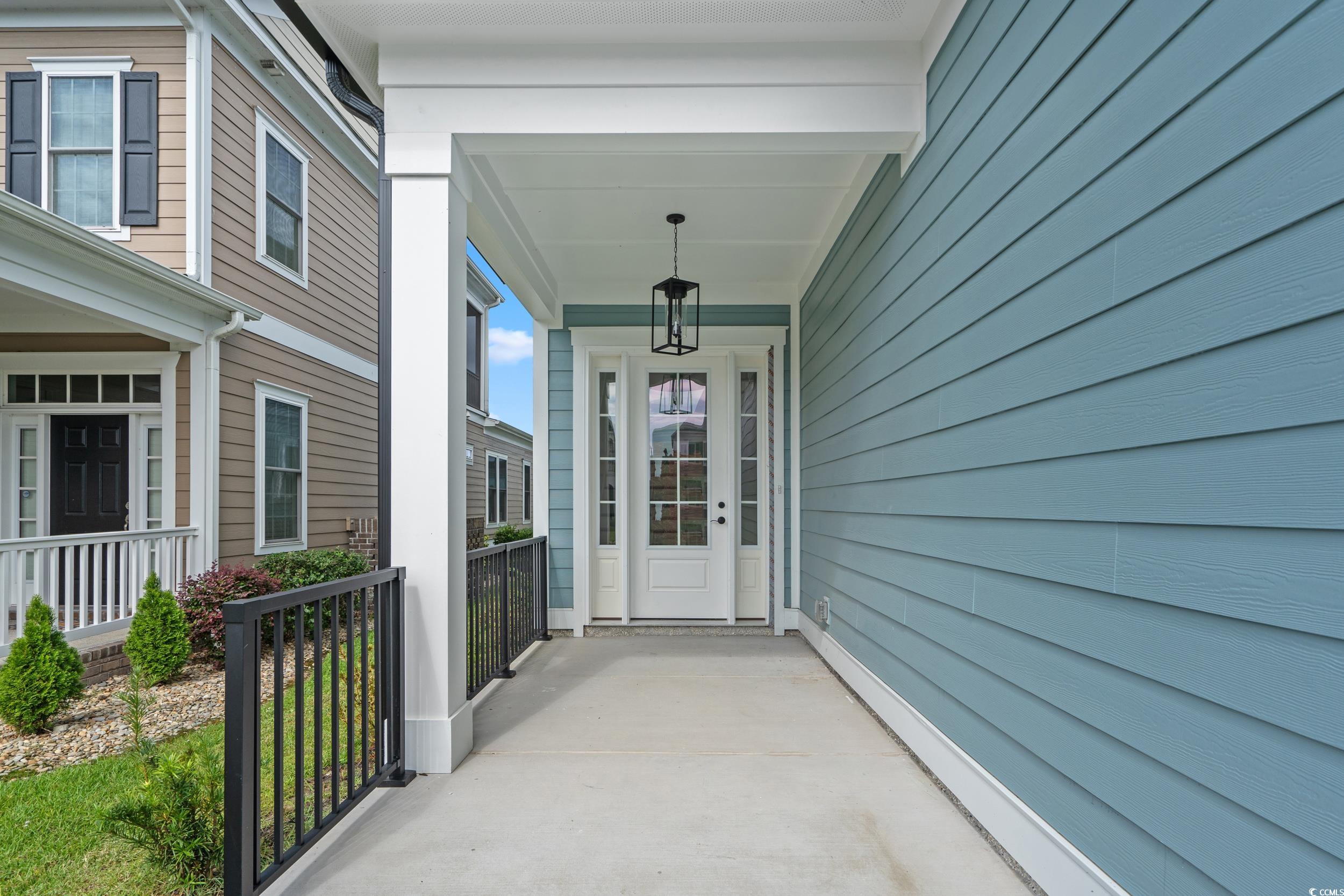921 Crystal Water Way Myrtle Beach, SC 29579 - Photo 4 of 36 Doorway to property featuring covered porch