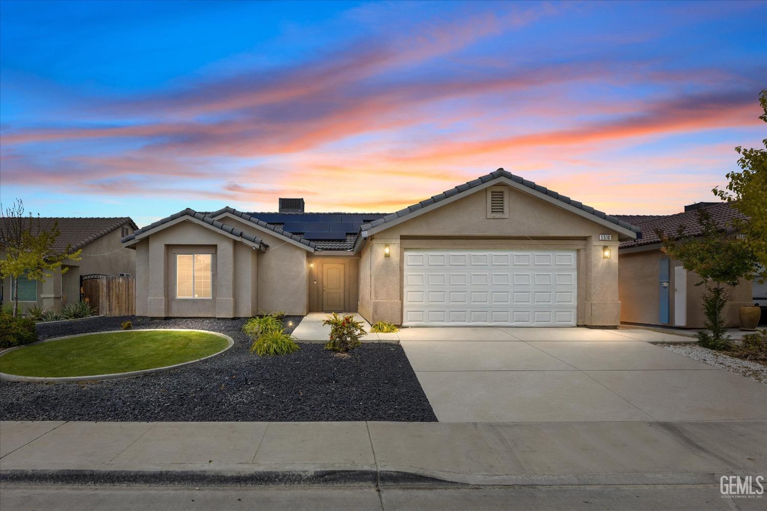 Undisclosed Address Bakersfield, CA 93307 - Photo 1 of 30 a front view of a house with a yard and garage