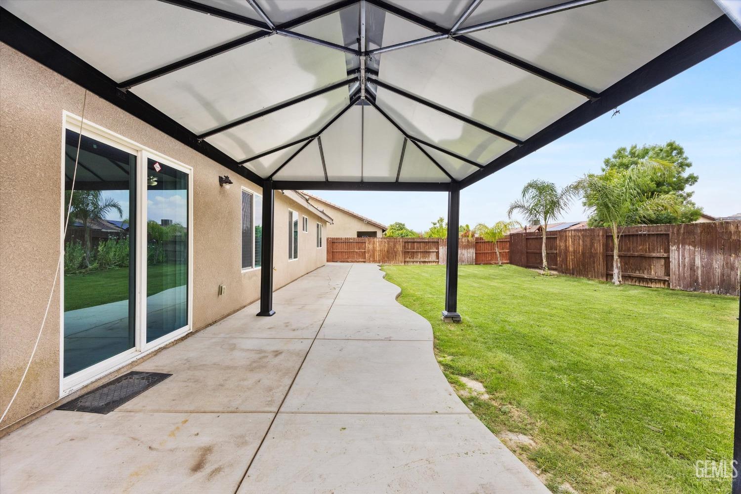 Undisclosed Address Bakersfield, CA 93307 - Photo 26 of 30 a view of a house with backyard and porch