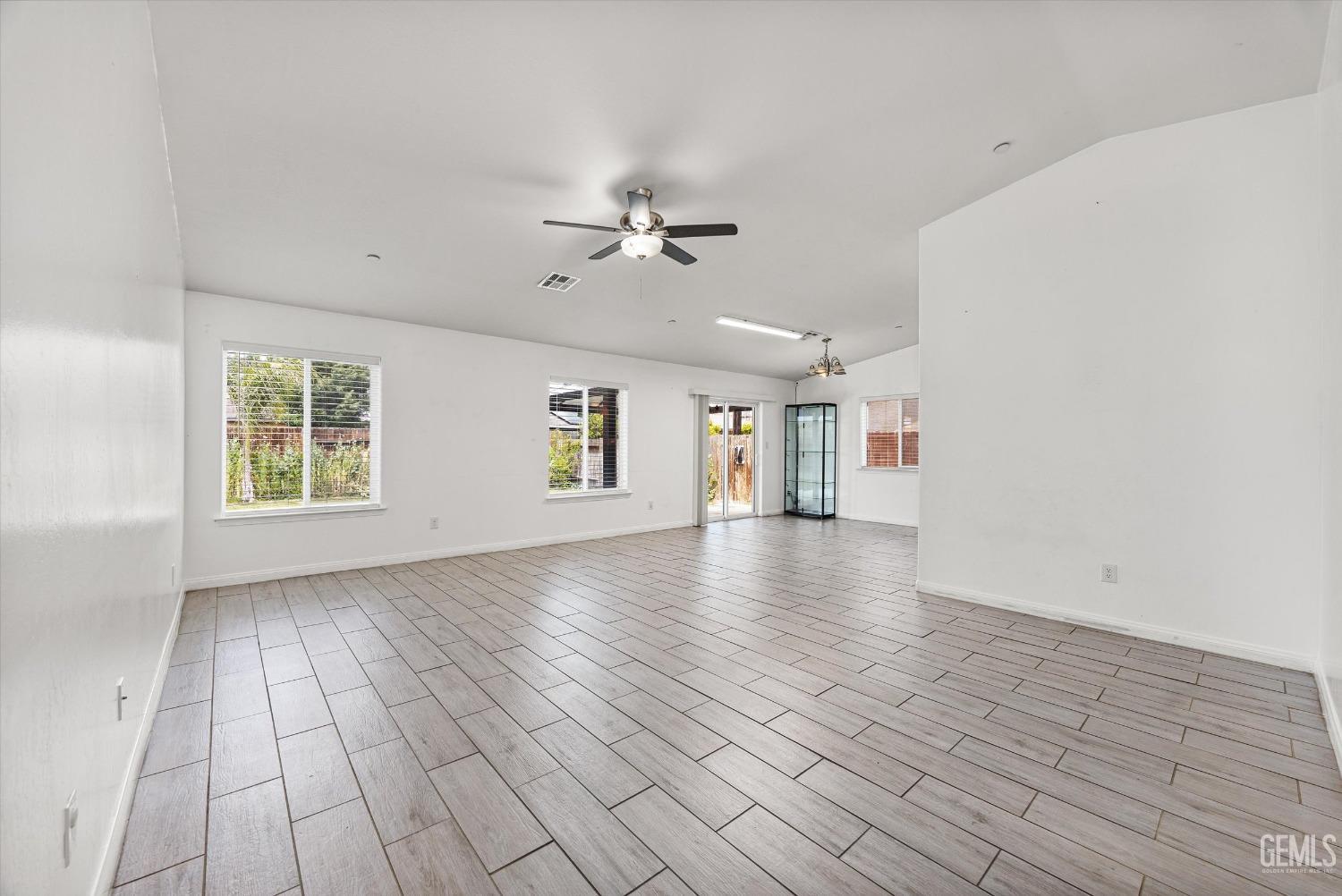 Undisclosed Address Bakersfield, CA 93307 - Photo 5 of 30 wooden floor in an empty room with a window