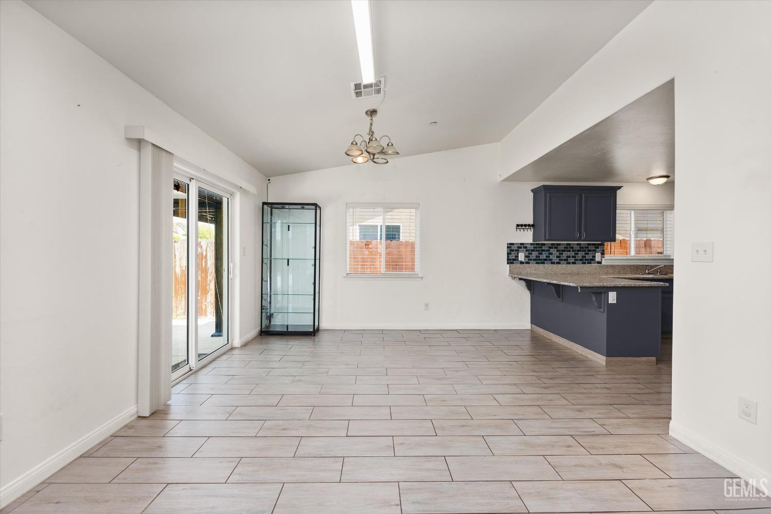 Undisclosed Address Bakersfield, CA 93307 - Photo 9 of 30 a view of a kitchen with a sink and a microwave