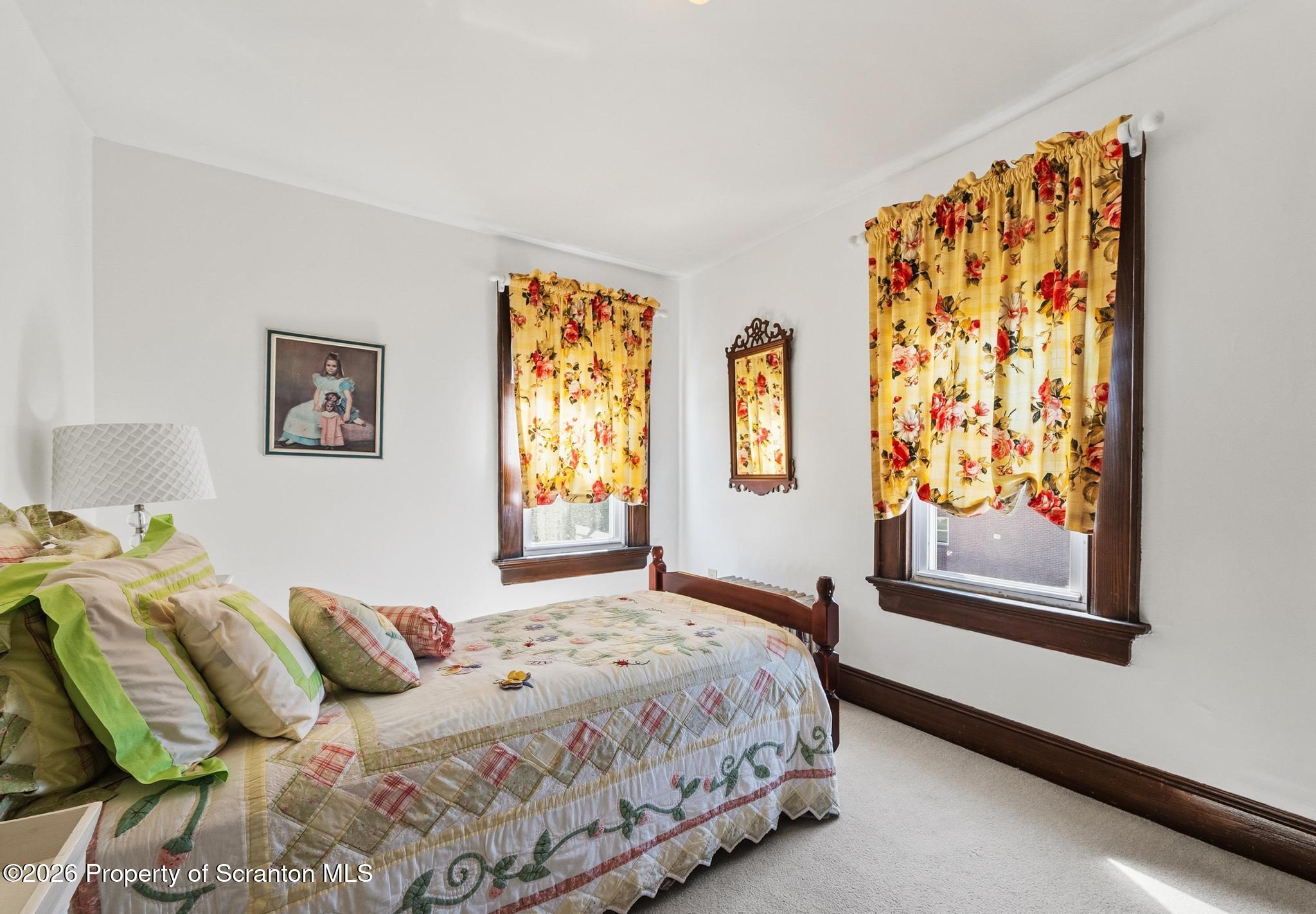 616 Myrtle Street Scranton, PA 18510 - Photo 28 of 65 a bedroom with a bed and a window