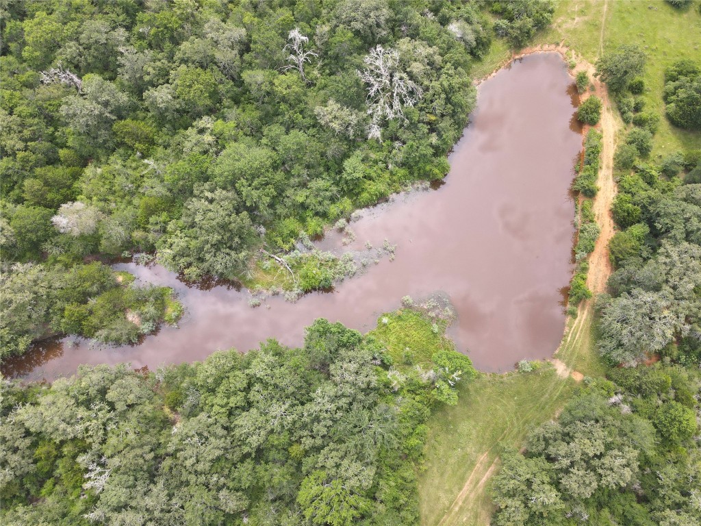 an aerial view of a house with a yard and garden