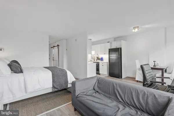 a bedroom with a bed and chair