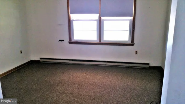 a view of a room with a sink and a mirror