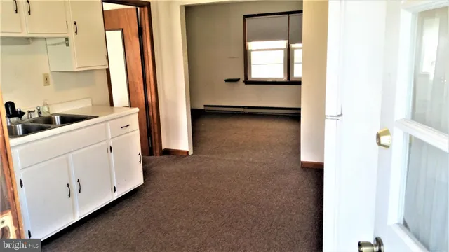 a view of a room with wooden floor and a chair