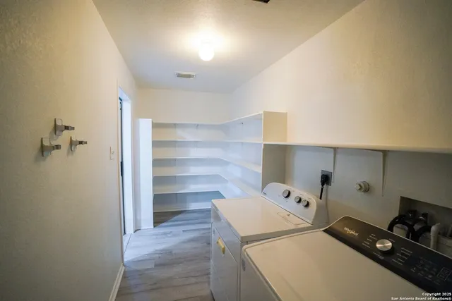 a utility room with cabinets dryer and washer