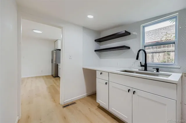 a kitchen with a sink cabinets and window