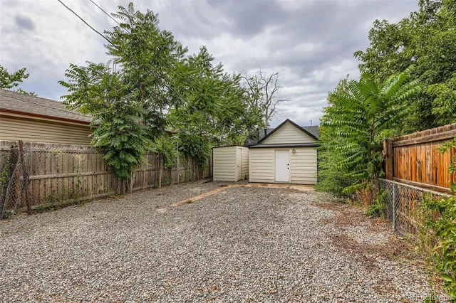 a view of backyard and wooden house