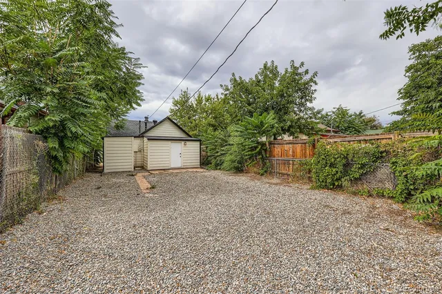a wooden house with trees in front of it