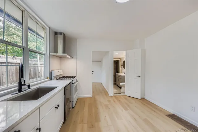 a kitchen with a sink stove and cabinets