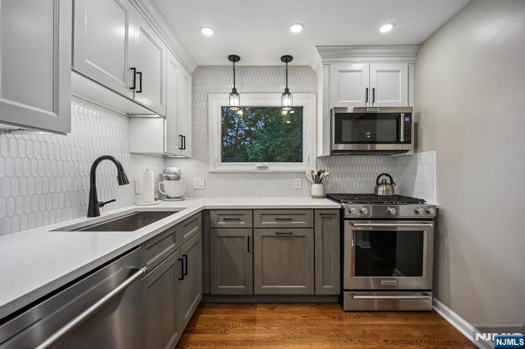 23 Andover Place Bloomfield, NJ 07003 - Photo 12 of 42 a kitchen with stainless steel appliances granite countertop a stove a sink and a microwave