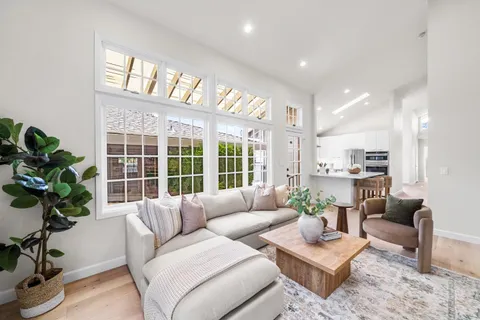 a living room with furniture a fireplace and a kitchen view