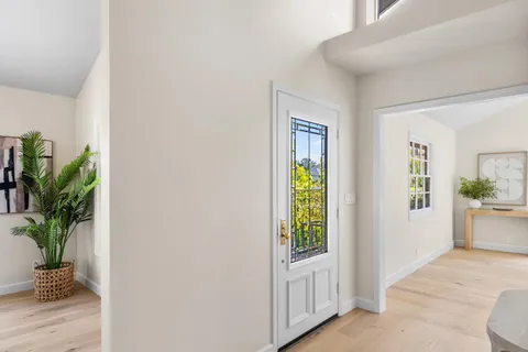 a living room with furniture a chandelier and a window