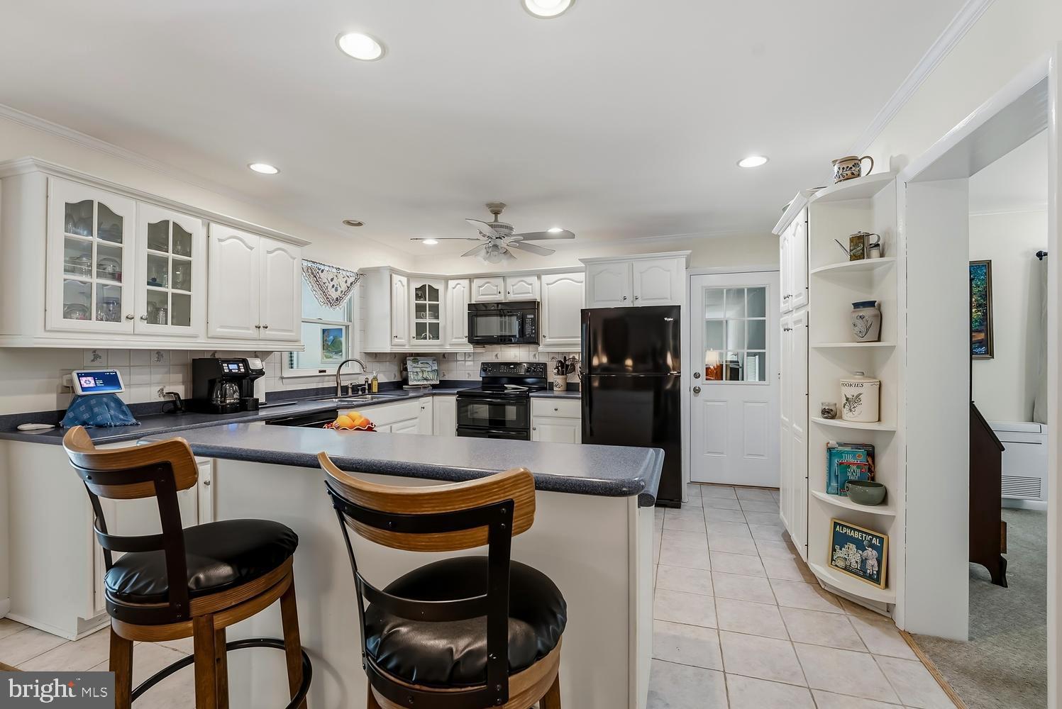 814 Wrights Neck Road Centreville, MD 21617 - Photo 35 of 53 a kitchen with stainless steel appliances a refrigerator a stove a sink cabinets and a dining table