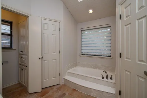 a bathroom with a tub a toilet and a shower