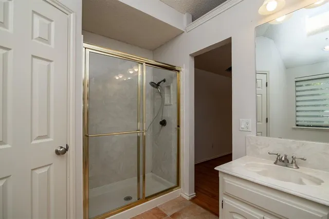 a bathroom with a shower and a sink