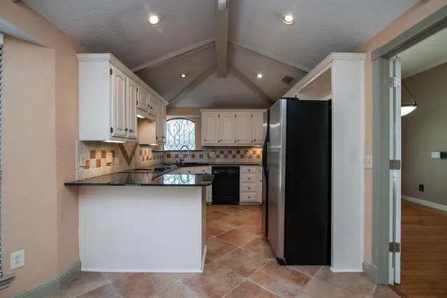 a kitchen with stainless steel appliances granite countertop a refrigerator and a sink