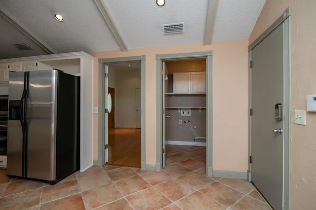 a view of a hallway with wooden shelves