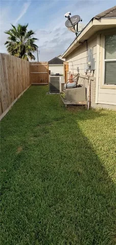 a view of a house with a yard and sitting area