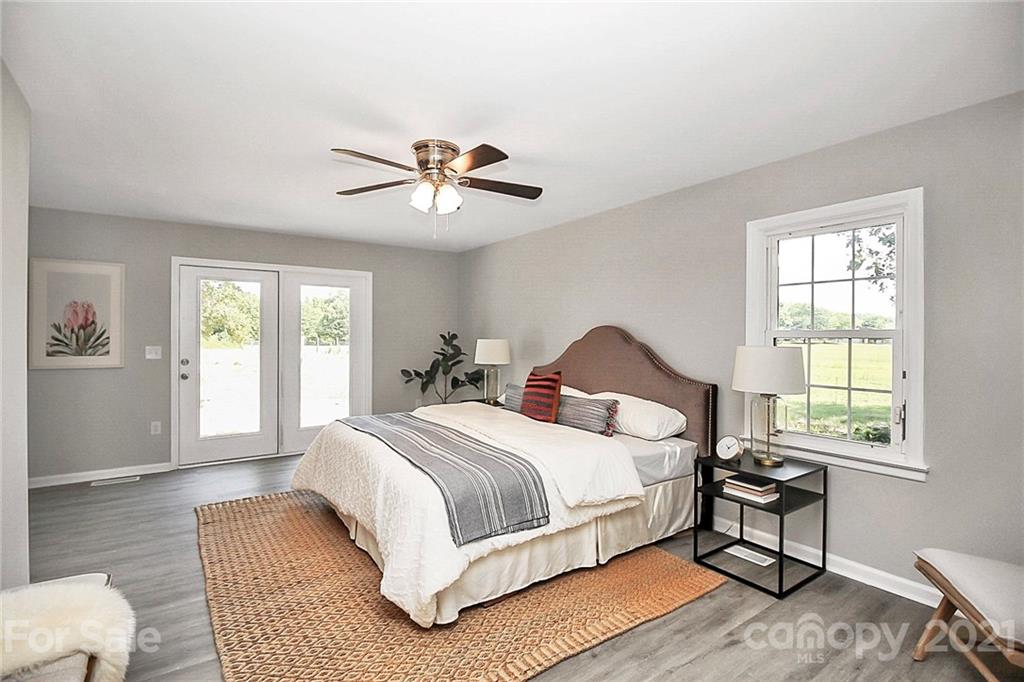 3405 Love Mill Road Monroe, NC 28110 - Photo 15 of 44 a bedroom with a large bed and a chandelier
