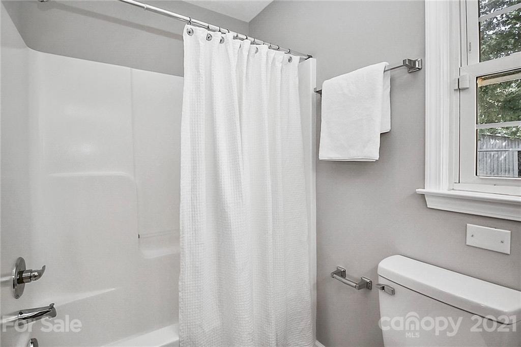 3405 Love Mill Road Monroe, NC 28110 - Photo 27 of 44 a bathroom with a shower curtain and a toilet