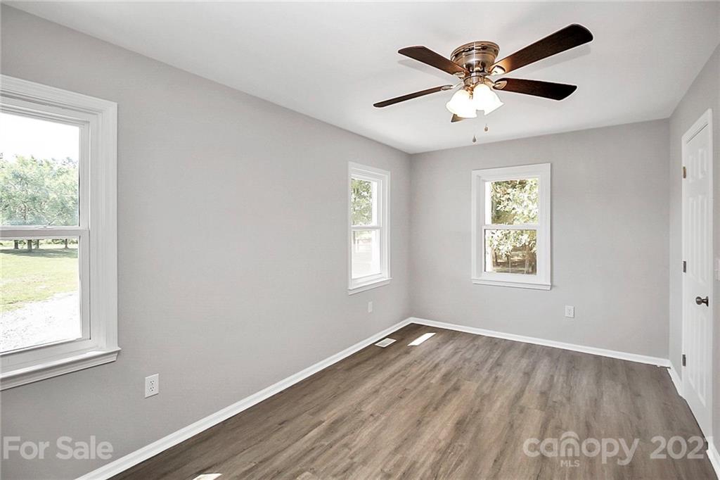 3405 Love Mill Road Monroe, NC 28110 - Photo 29 of 44 a view of empty room with wooden floor and fan