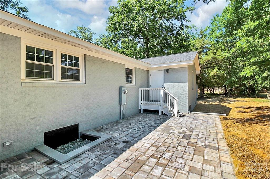 3405 Love Mill Road Monroe, NC 28110 - Photo 35 of 44 a backyard of a house with barbeque oven and outdoor seating
