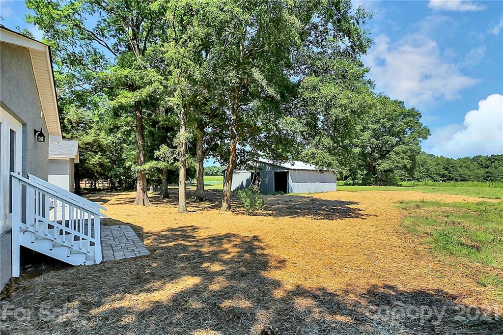 3405 Love Mill Road Monroe, NC 28110 - Photo 38 of 44 a view of a house with backyard and trees