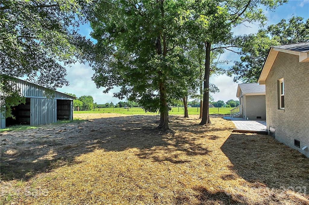 3405 Love Mill Road Monroe, NC 28110 - Photo 39 of 44 a view of a yard with plants and large trees