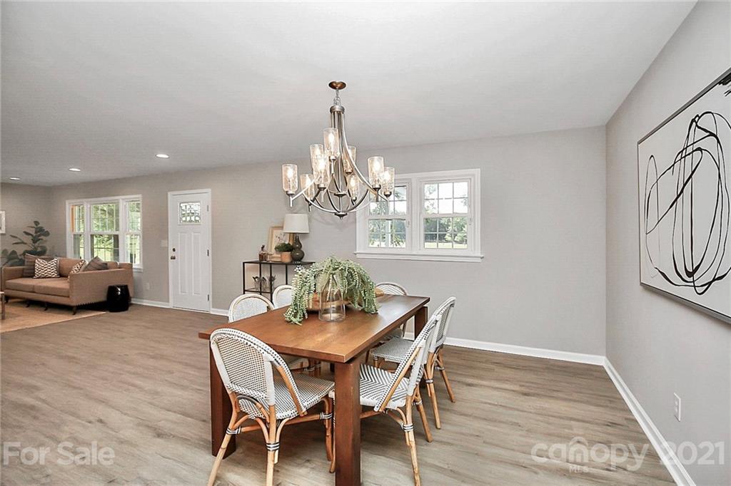 3405 Love Mill Road Monroe, NC 28110 - Photo 8 of 44 a view of a dining room with furniture a chandelier and wooden floor
