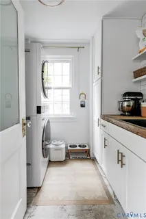 a kitchen with a sink a refrigerator and window