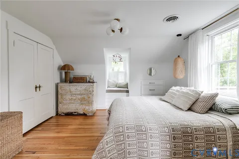 a bedroom with a bed and a potted plant
