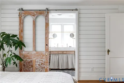a en suite bathroom with a sink mirror and a shower