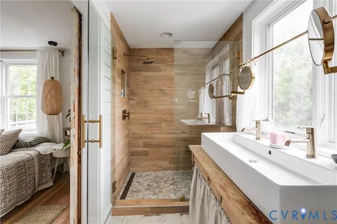 a bathroom with a sink a toilet and a window