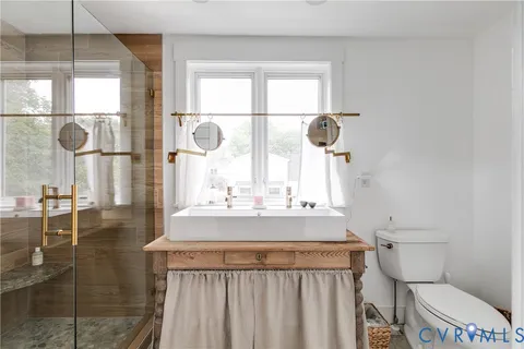 a living room with furniture and a dresser