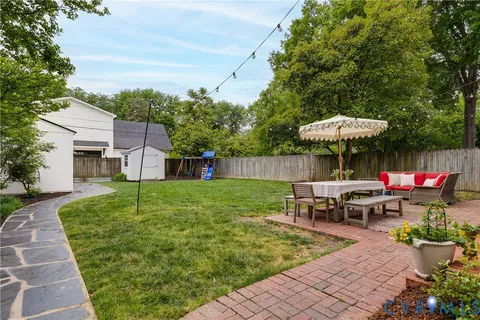 a view of a house with a backyard and a slide
