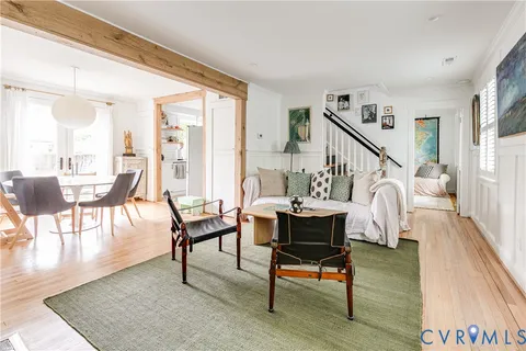 a dining room with wooden floor a glass table and chairs