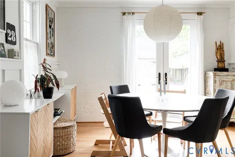 a view of a dining room with furniture and a chandelier