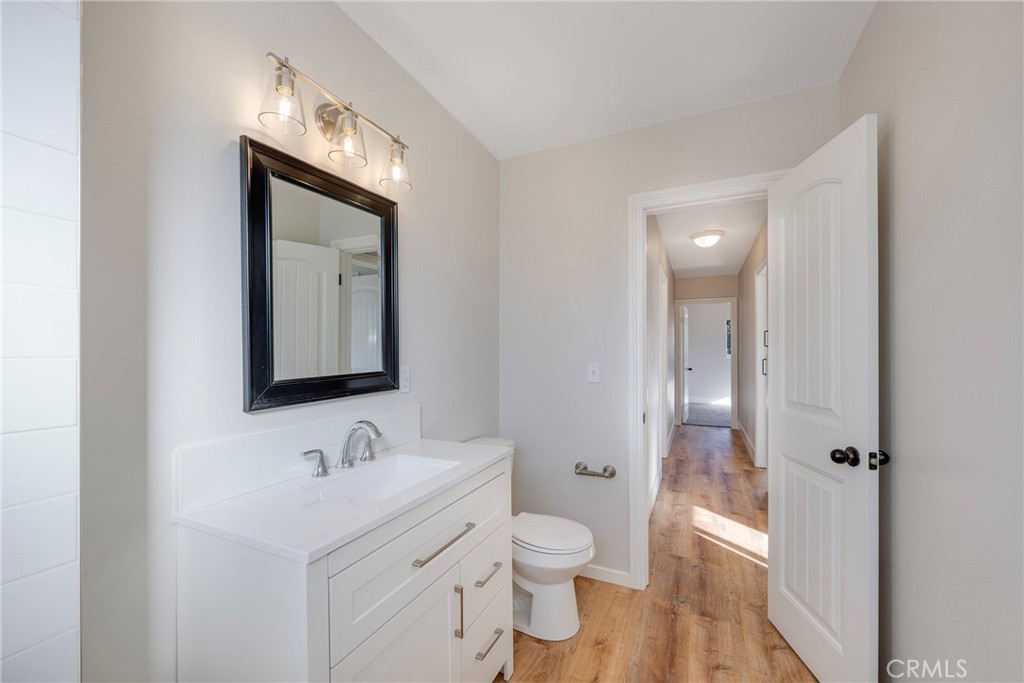 8214 Klusman Avenue Rancho Cucamonga, CA 91730 - Photo 28 of 39 a bathroom with a toilet sink a mirror and vanity