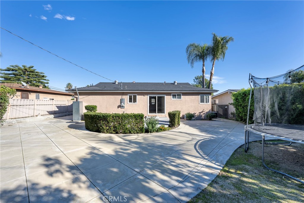 8214 Klusman Avenue Rancho Cucamonga, CA 91730 - Photo 35 of 39 a front view of a house with a yard and a garage