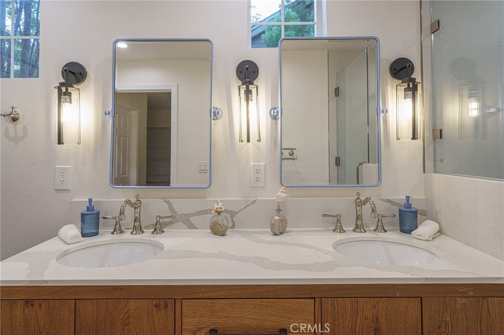 17 Oatfield Farm Ladera Ranch, CA 92694 - Photo 44 of 57 The primary bathroom lives like a spa retreat. Custom lighting, polished nikel Brizo hardware, cabinetry, custom geometric terracotta floor tiles, porceline tiles in shower, all reflect "quiet luxury". Additionally there is a Toto bidet toilet with heated seat!