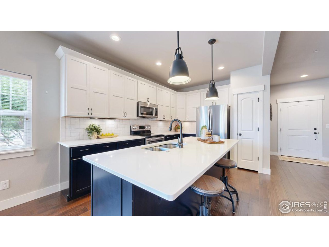 3926 Precision Drive, Unit E Fort Collins, CO 80528 - Photo 7 of 38 a living room with stainless steel appliances kitchen island a table and chairs