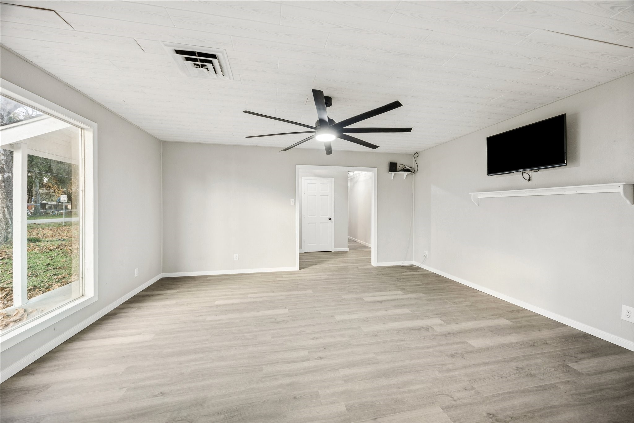 11910 11th Street Santa Fe, TX 77510 - Photo 3 of 30 a view of an empty room with a flat screen tv