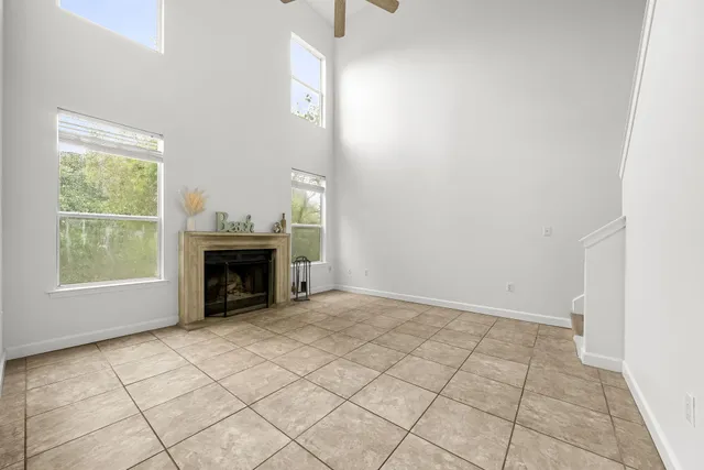 a view of an empty room with a fireplace and a window