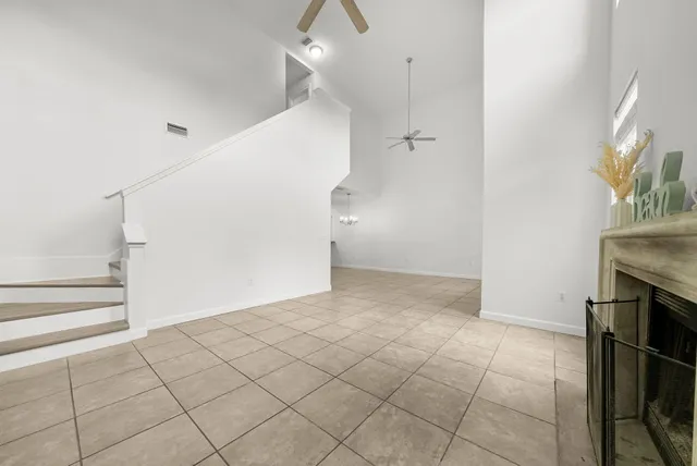 a view of an empty room and entryway with a fireplace