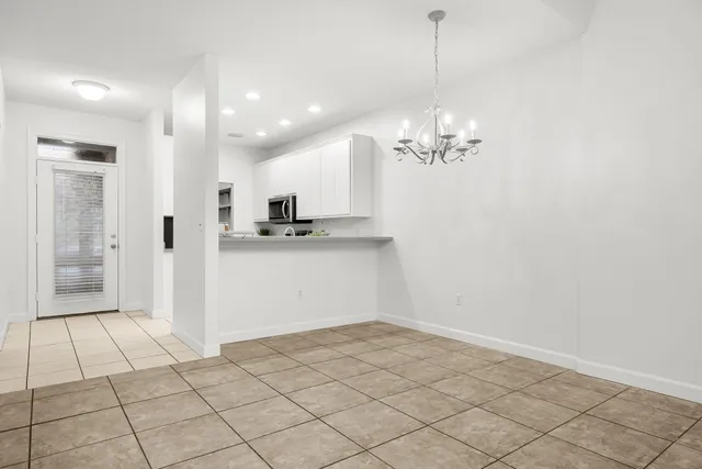 a view of a kitchen with wooden floor and a chandelier